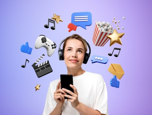 Portrait,Of,Smiling,Young,Woman,Using,Smartphone,And,Headphones,Standing